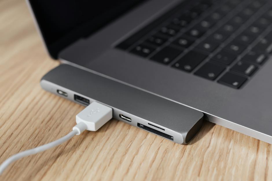 A person holding a broken laptop charger cable, symbolizing frustration with Dell laptop charger problems.